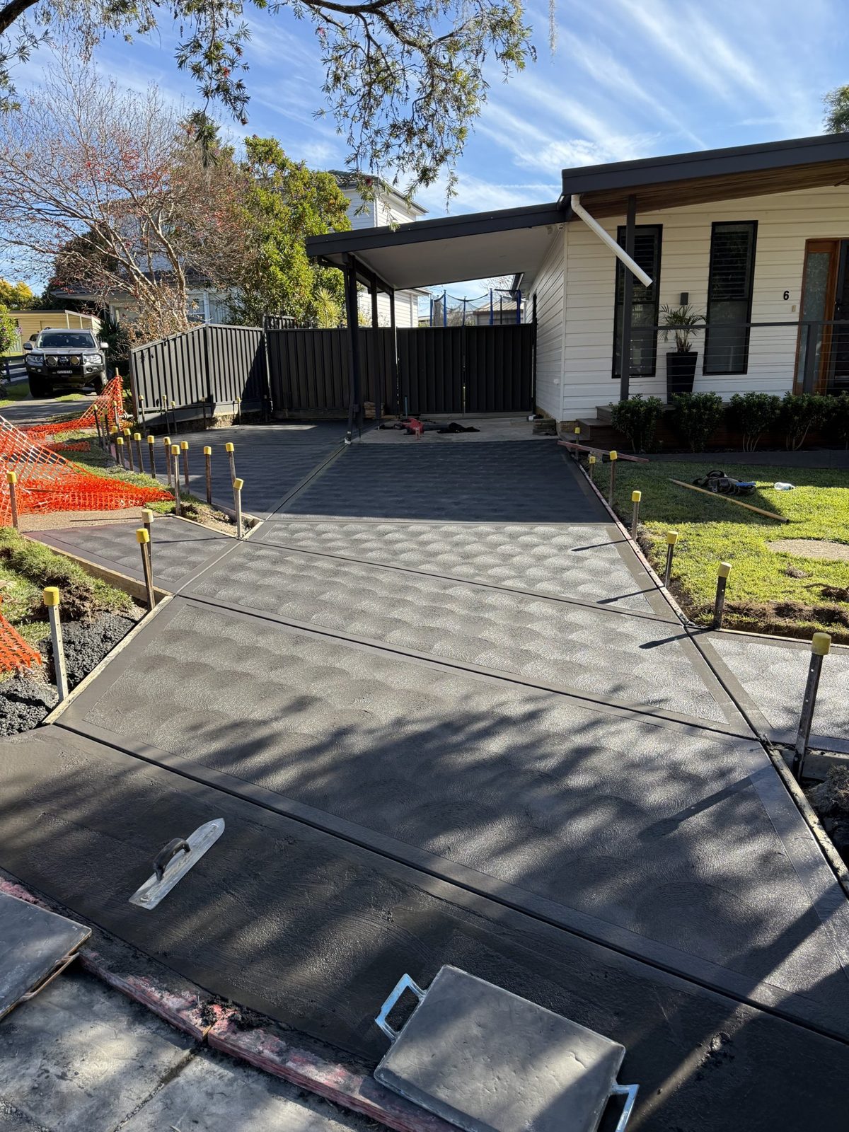 Concrete driveway formwork during the pour by EAB Concreting, Hunter Valley