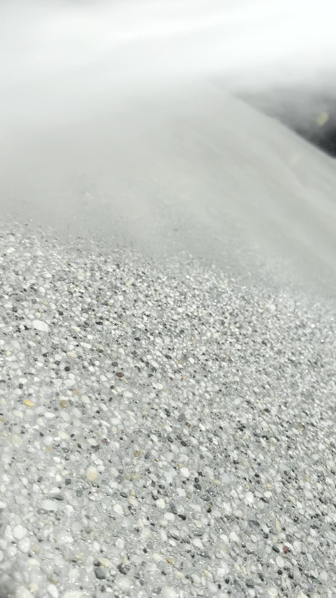 Exposed aggregate concrete being washed off to reveal the stones by EAB Concreting, Hunter Valley